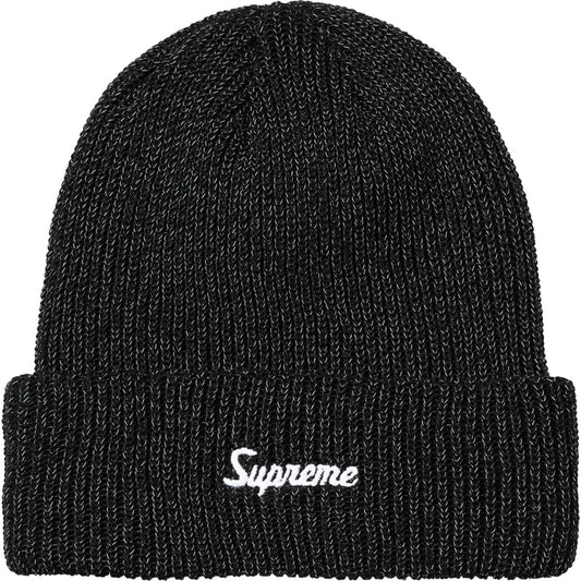 Black loose gauge reflective beanie with white Supreme script, normal lighting
