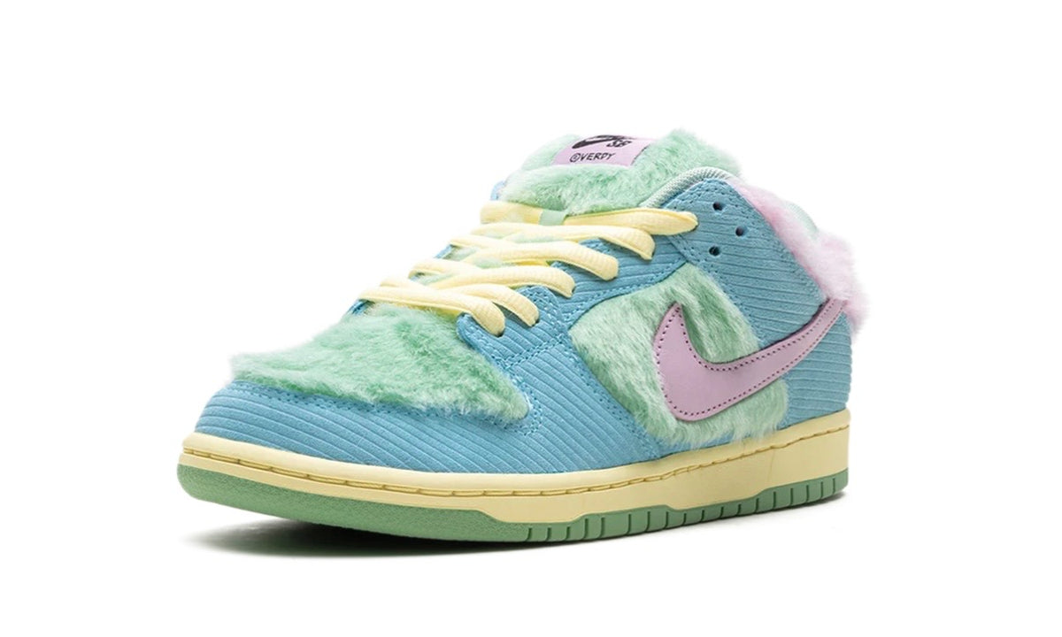 Angled view of blue corduroy SB Dunk Low with mint fur and lilac Verdy tongue tag