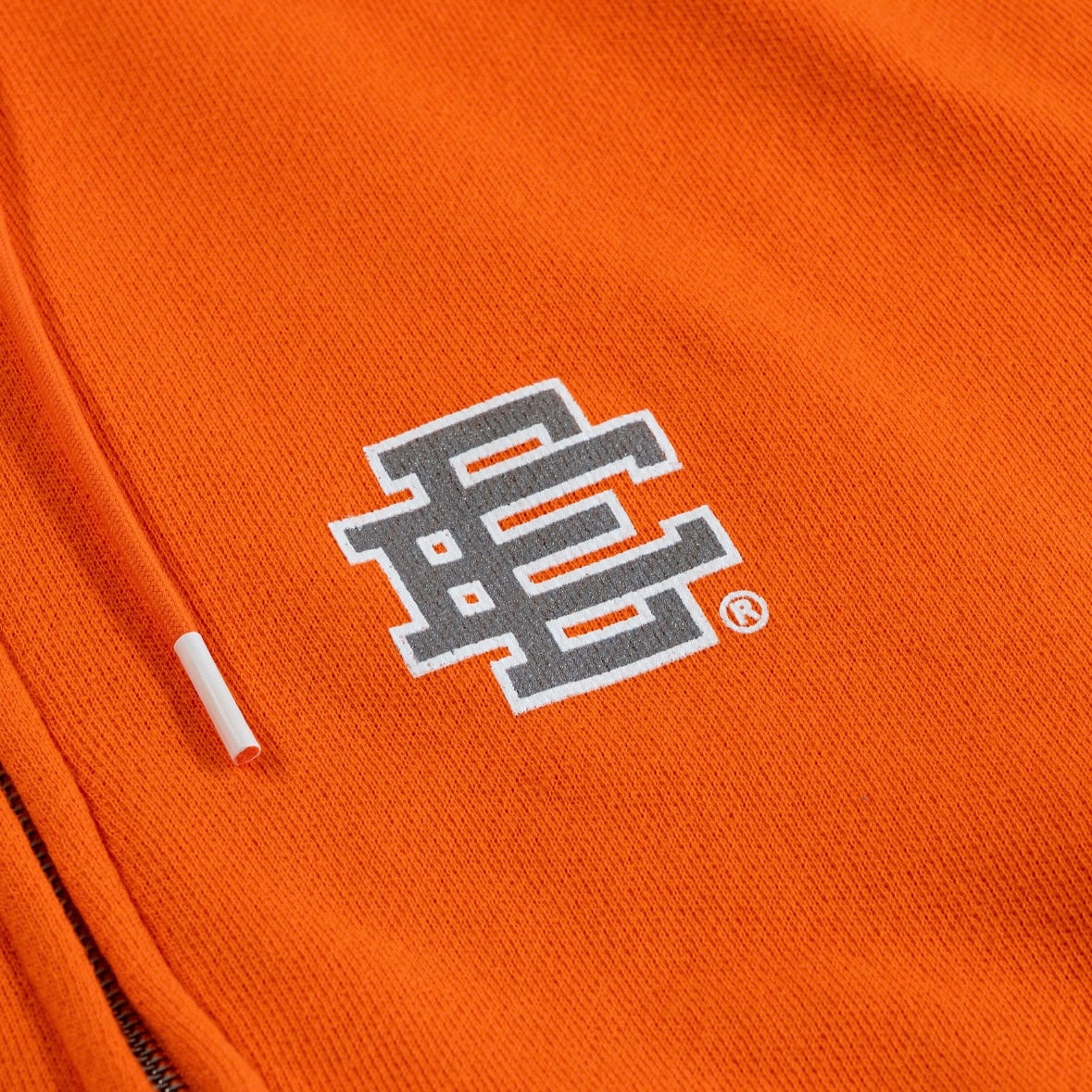 Eric Emanuel Orange Zip Hoodie logo