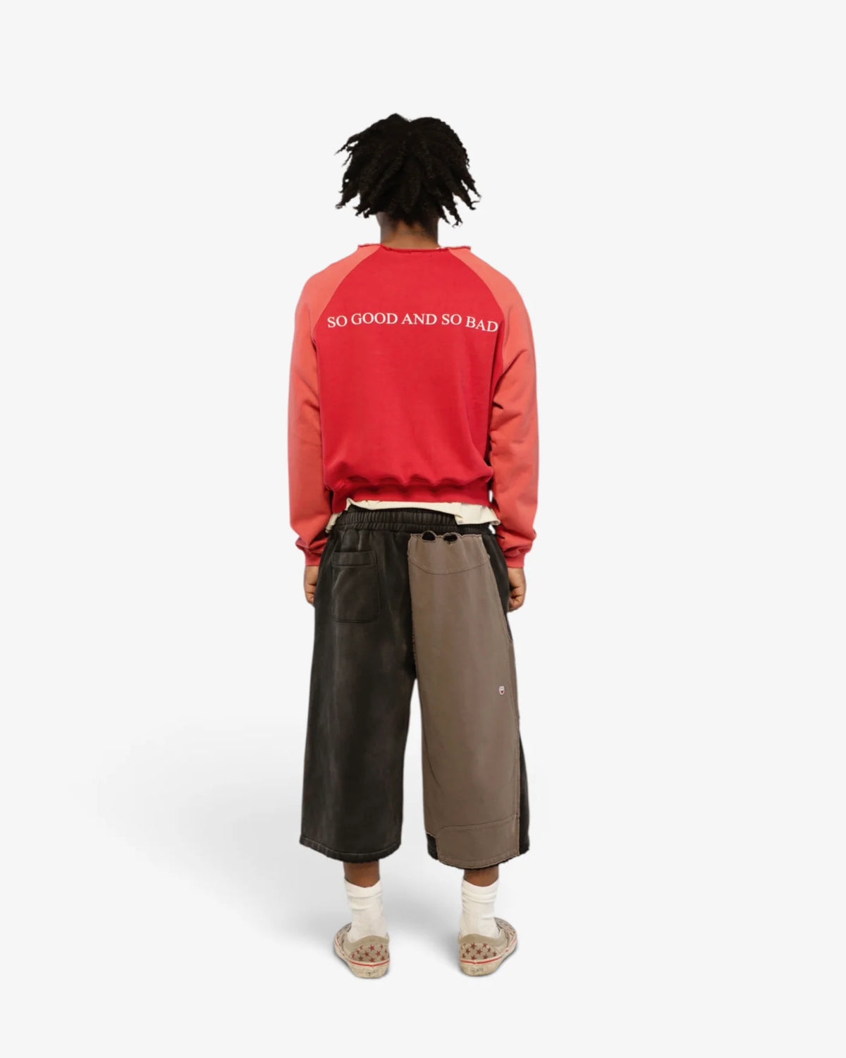 Model wearing the Fire Of Desire crewneck with long shorts, back view