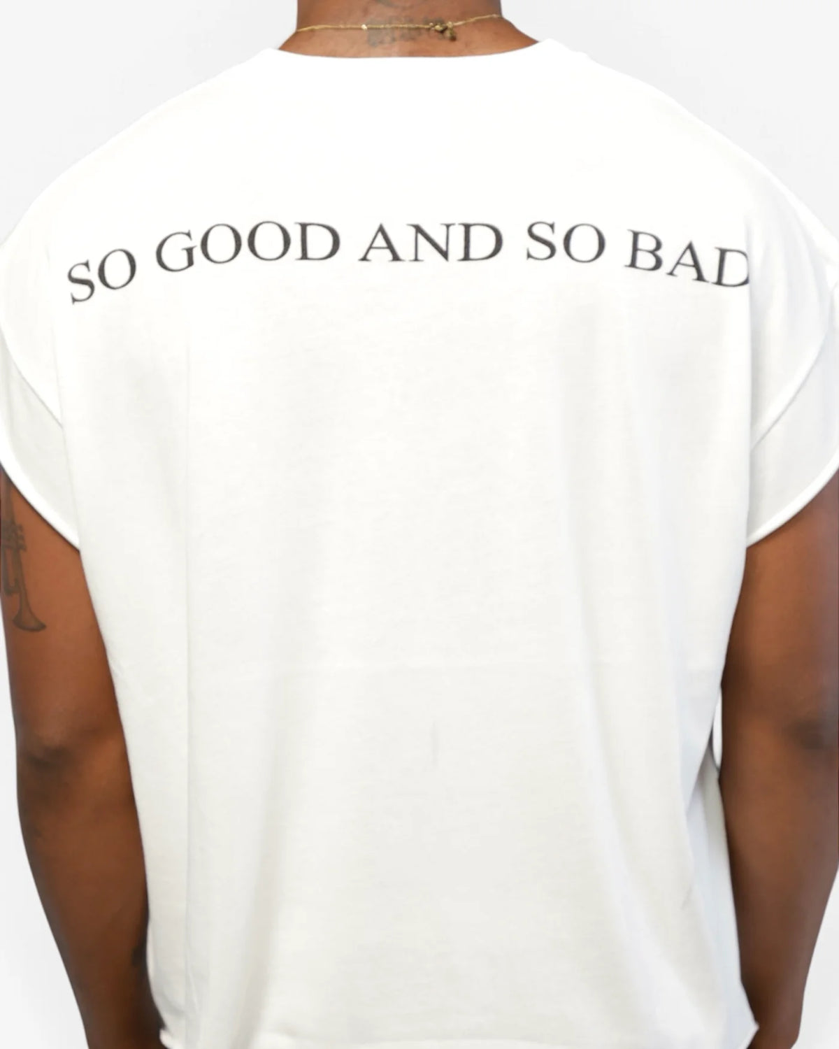 Close back shot of male model showing SO GOOD AND SO BAD print on white tee