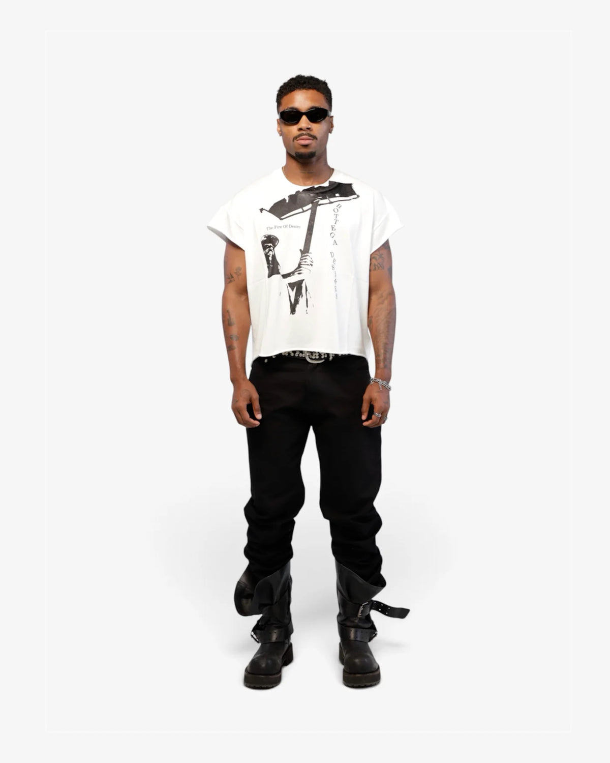 Male model in white cut-off tee with black trousers and black boots, full length