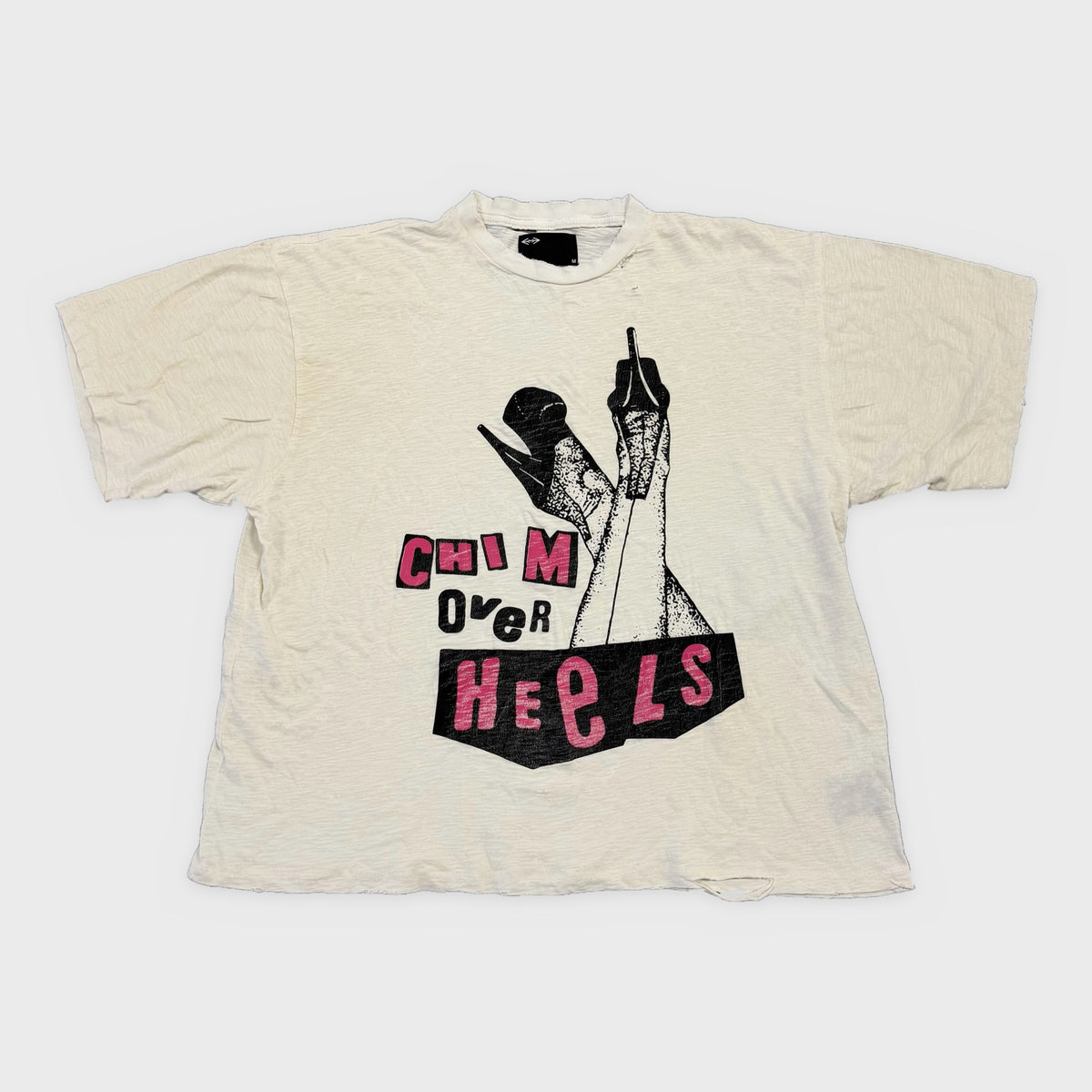 HMDD White Chim Over Heels T-Shirt, cream tee with a black and pink cut-out Chim Over Heels graphic of legs in heels