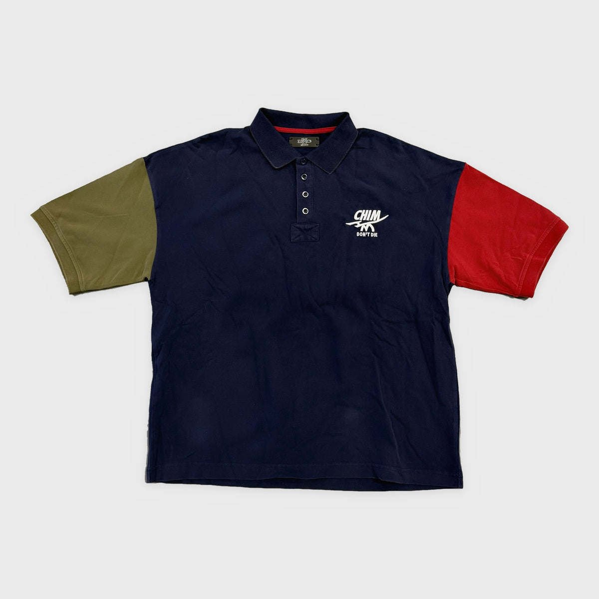 HMDD Colorblock Polo, navy polo with olive and red contrast sleeves and a white embroidered Chim chest logo
