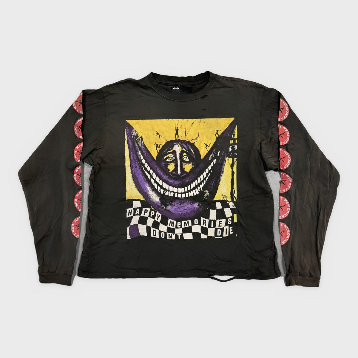 HMDD Black Smiley Long Sleeve, faded black long sleeve with a purple grin on yellow, checkerboard banner and pink sleeve prints