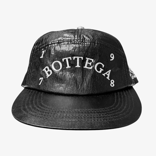 Bottega Desires 1978 Hat front in glossy crinkled black with arched white BOTTEGA embroidery and 1978 numerals