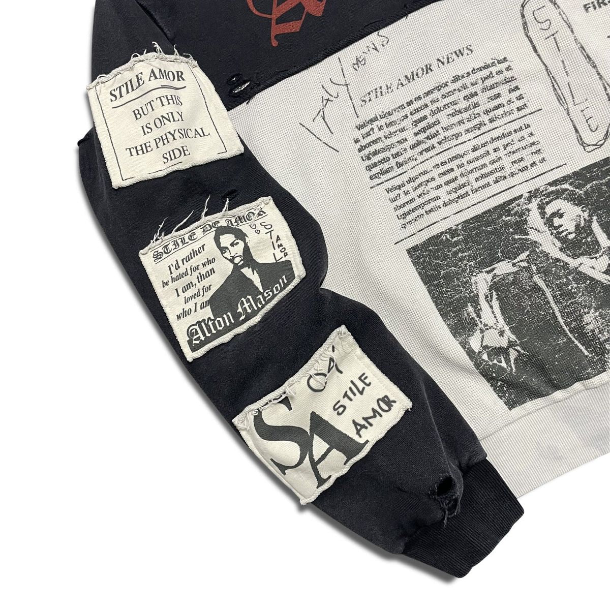 Close-up of the raw-edge sewn patches on the sleeve of the Stile De Amor Nero Patch Hoodie