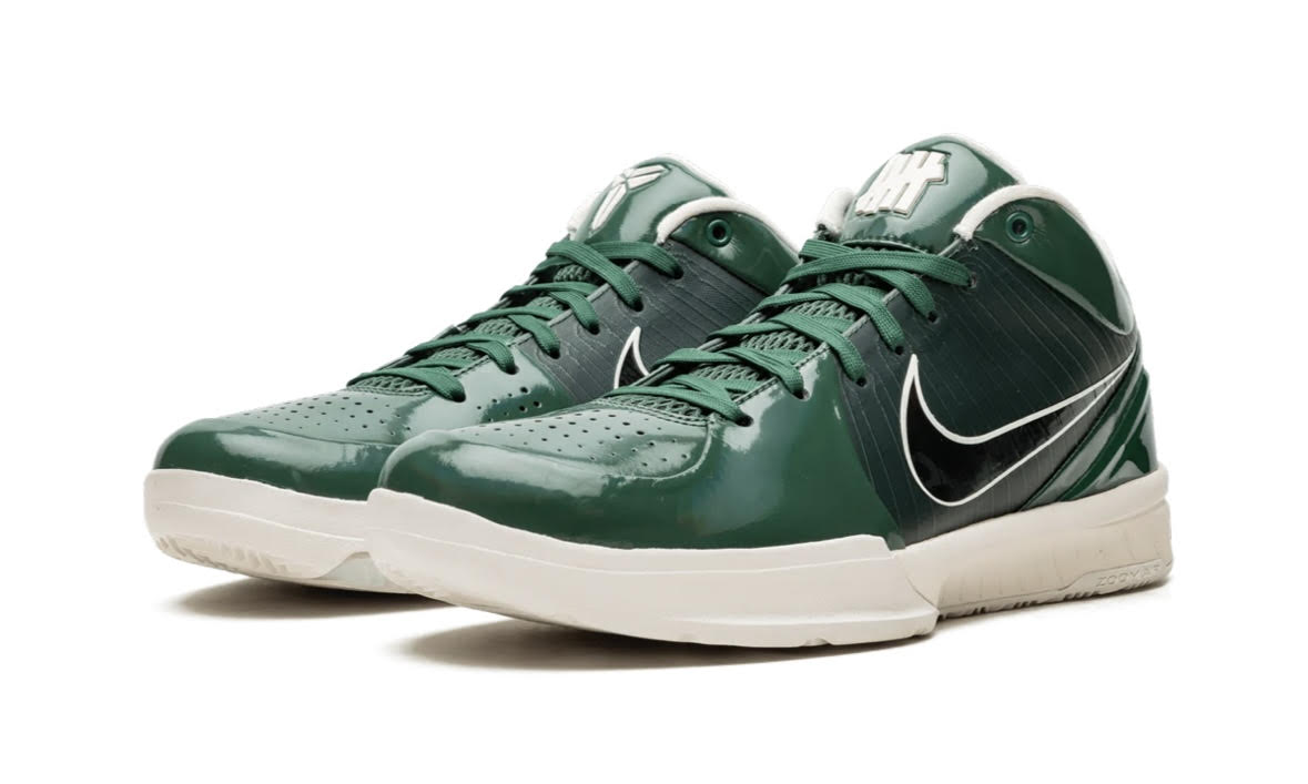 Nike Kobe 4 Protro Undefeated Milwaukee Bucks, front three-quarter of the green pair with white Swooshes and cream soles