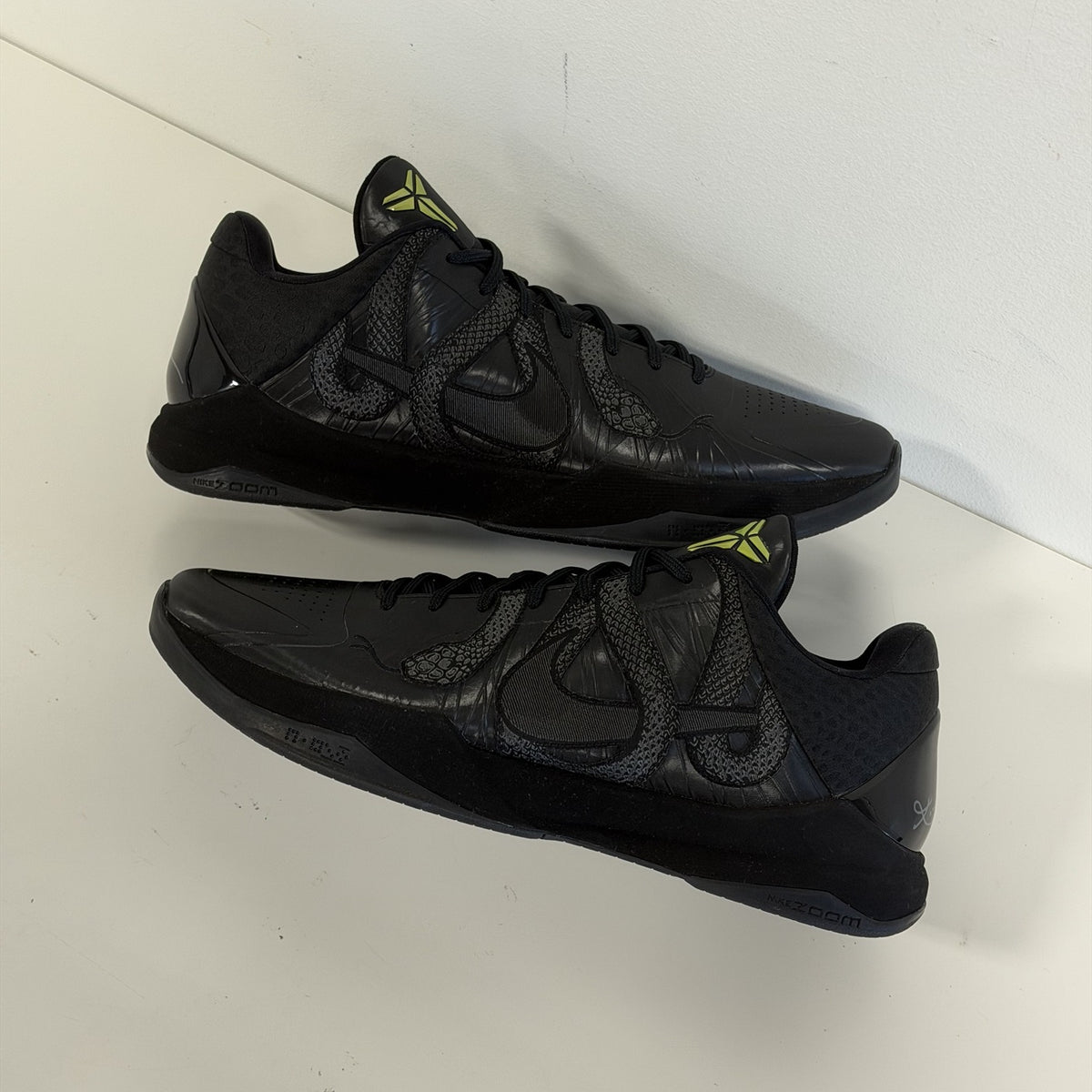Nike Kobe 5 Protro Year of the Mamba Black, both shoes stacked showing the Nike Zoom midsole and snake overlay