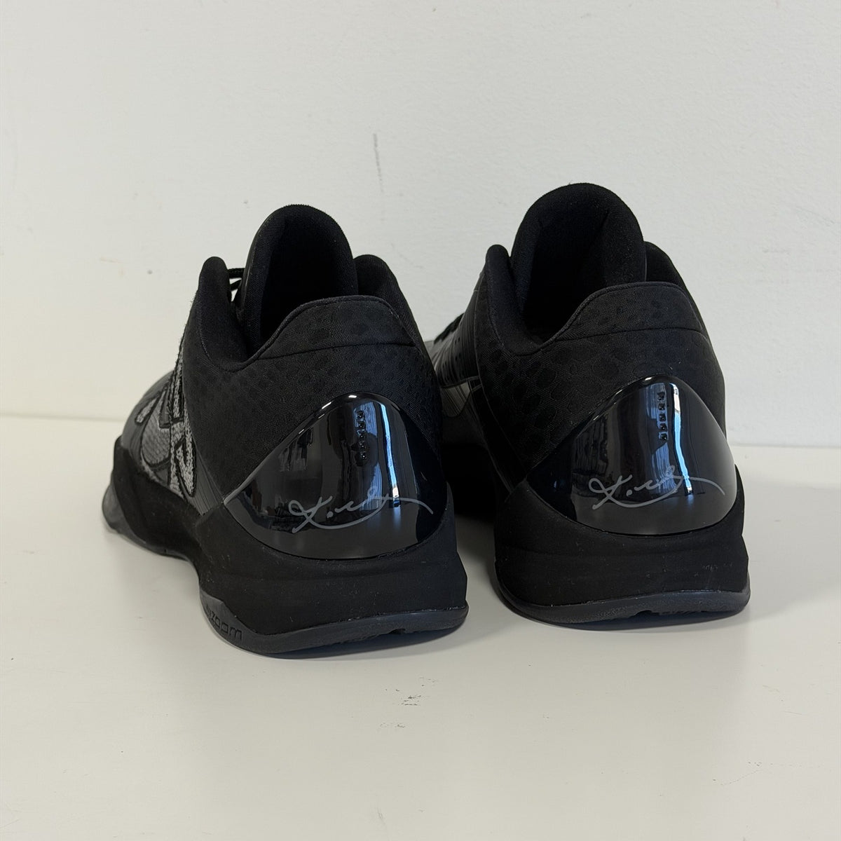 Nike Kobe 5 Protro Year of the Mamba Black, heel view with glossy heel counters and Kobe signature