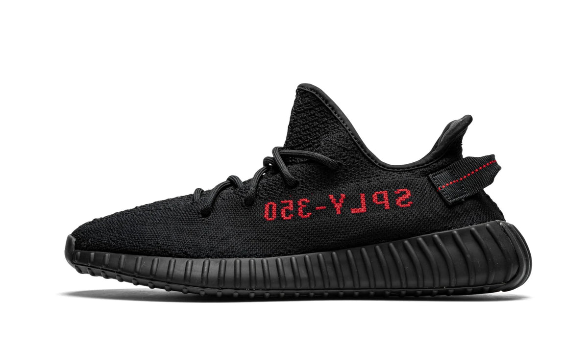 Yeezy 350 V2 Black Red, lateral profile of the black knit low-top with red SPLY-350 lettering on the stripe.