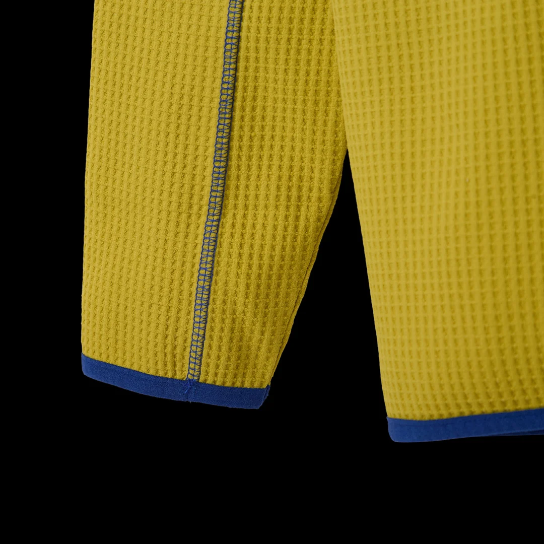 Close-up of the sleeve cuffs with blue trim and grey contrast stitching