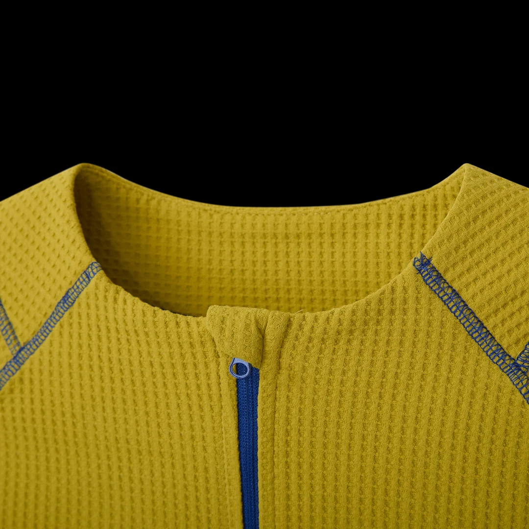 Close-up of the collar and blue zip on the mustard GV Gallery Training Quarter Zip